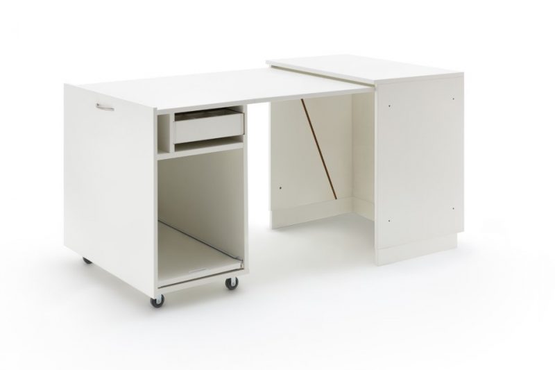 An extended sewing table with drawers and wheels
